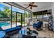 Enclosed sunroom with outdoor kitchen, comfortable seating, and a clear view of the pool at 1106 Ayrshire St, Orlando, FL 32803