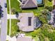 Aerial view of a home with a pool, solar panels, and manicured landscaping at 1124 Shadowbrook Trl, Winter Springs, FL 32708
