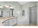 Bathroom featuring a tub, a shower, white cabinets, and a window, providing natural light at 1124 Shadowbrook Trl, Winter Springs, FL 32708