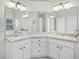 Spacious bathroom featuring dual sinks with white cabinets, a large mirror, and recessed lighting at 1124 Shadowbrook Trl, Winter Springs, FL 32708