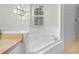 Bathroom featuring a tub, a shower, and a window, offering a bright and airy space at 1124 Shadowbrook Trl, Winter Springs, FL 32708