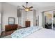 Bedroom with a bed, a dresser, a ceiling fan, and a sliding door to the patio at 1124 Shadowbrook Trl, Winter Springs, FL 32708