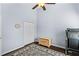 Light-filled bedroom with neutral walls, ceiling fan, closet, and wood-look flooring at 1124 Shadowbrook Trl, Winter Springs, FL 32708
