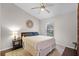 Cozy bedroom featuring a window, a ceiling fan, and an area rug on hardwood floors at 1124 Shadowbrook Trl, Winter Springs, FL 32708