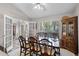 Elegant dining room featuring a large wooden table, comfortable seating, and a built-in hutch at 1124 Shadowbrook Trl, Winter Springs, FL 32708