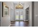 Inviting foyer with wood-look floors, transom windows, and double glass entry doors at 1124 Shadowbrook Trl, Winter Springs, FL 32708