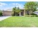 Charming single-story home with well-manicured lawn, lush landscaping, and double-door entry at 1124 Shadowbrook Trl, Winter Springs, FL 32708