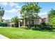 Charming single-Gathering home with a lush green lawn and mature landscaping at 1124 Shadowbrook Trl, Winter Springs, FL 32708
