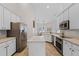 Well-appointed kitchen with white cabinets, stainless steel appliances, and a center island at 1124 Shadowbrook Trl, Winter Springs, FL 32708