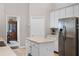 Bright kitchen with white cabinets, stainless steel appliances, and a functional center island at 1124 Shadowbrook Trl, Winter Springs, FL 32708