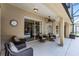 Covered patio with comfortable seating, ceiling fan, and sliding glass doors at 1124 Shadowbrook Trl, Winter Springs, FL 32708