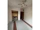 Small bedroom with unfinished floors, fresh paint, closet space, and a ceiling fan at 11625 Churchill St, Orlando, FL 32817