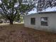 Exterior shot of property with a large tree in the front yard at 11625 Churchill St, Orlando, FL 32817