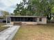 Modest single story home with screened-in porch, concrete drive and mature trees at 11625 Churchill St, Orlando, FL 32817