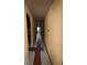 Long hallway featuring curved entries and dated color schemes at 11625 Churchill St, Orlando, FL 32817