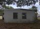 Exterior shot of the back of the home with two windows at 11625 Churchill St, Orlando, FL 32817