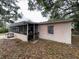 View of the rear exterior with covered patio at 11625 Churchill St, Orlando, FL 32817