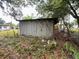 Exterior view of a backyard shed in disrepair at 11625 Churchill St, Orlando, FL 32817