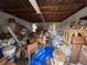 Storage room is cluttered with furniture, boxes, and construction material at 11625 Churchill St, Orlando, FL 32817