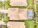 Aerial view of the home's roof and backyard oasis with pool and screened enclosure at 11885 Padua Ln, Orlando, FL 32827