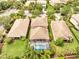 Aerial view showcasing the home, landscaping, and the screened-in pool area at 11885 Padua Ln, Orlando, FL 32827