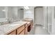 Bathroom with double vanity, granite countertops, large mirror and bright white trim at 11885 Padua Ln, Orlando, FL 32827