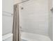 Clean bathroom features a bathtub with tiled walls and a shower curtain at 11885 Padua Ln, Orlando, FL 32827