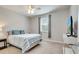 Comfortable bedroom with a queen bed, modern furniture, and natural light at 11885 Padua Ln, Orlando, FL 32827