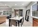 Kitchen dining area with a marble top table and contemporary chairs, featuring sliding glass doors to an outdoor living space at 11885 Padua Ln, Orlando, FL 32827