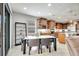 Open dining area features a marble top table, modern decor, a glass display cabinet, and is adjacent to the kitchen at 11885 Padua Ln, Orlando, FL 32827