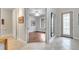 Inviting foyer with tile flooring, art, and open view to adjacent room with hardwood floors at 11885 Padua Ln, Orlando, FL 32827