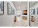 Elegant hallway with art, neutral walls, tile flooring, and bright, open feel at 11885 Padua Ln, Orlando, FL 32827