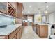 Open concept kitchen with stainless steel appliances, granite countertops, wine rack, and a kitchen island with a sink at 11885 Padua Ln, Orlando, FL 32827
