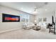 Well-lit living room with comfortable seating, a large window, and modern artwork at 11885 Padua Ln, Orlando, FL 32827