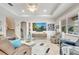 Open living room features tile floors, a tray ceiling with fan, glass tables, and contemporary furniture at 11885 Padua Ln, Orlando, FL 32827