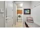 Mud room features a granite bench seat, coat hooks, and opens to a laundry room with front loading washer and dryer at 11885 Padua Ln, Orlando, FL 32827