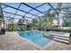 Screened pool with attached spa and waterfall feature in a private backyard setting at 11885 Padua Ln, Orlando, FL 32827