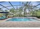 Enclosed pool and spa combo with waterfall features and lush landscaping for privacy at 11885 Padua Ln, Orlando, FL 32827