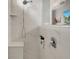 Modern tiled shower with built in bench and recessed shampoo shelf at 11885 Padua Ln, Orlando, FL 32827