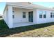 The home features a covered back patio and lush green grass at 1374 Brentwood Dr, Kissimmee, FL 34746