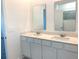 Bathroom featuring double sinks with white cabinets and granite countertop at 1374 Brentwood Dr, Kissimmee, FL 34746