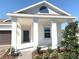Close-up view of the home's inviting covered front porch with white pillars and a stylish blue front door at 1374 Brentwood Dr, Kissimmee, FL 34746