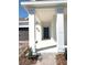 Stylish blue front door with white pillars supporting the covered front porch and attractive landscaping at 1374 Brentwood Dr, Kissimmee, FL 34746