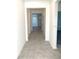 Bright hallway with gray tile floors leading into other rooms of the home at 1374 Brentwood Dr, Kissimmee, FL 34746