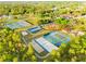 This aerial view highlights community tennis, basketball, and pickleball courts surrounded by lush trees and green spaces at 14961 Sw 38Th Cir, Ocala, FL 34473