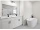 Bathroom with a soaking tub, double vanity with black fixtures and a large mirror at 14961 Sw 38Th Cir, Ocala, FL 34473