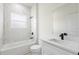 Bright bathroom with marble-look shower, quartz countertop, and black hardware fixtures at 14961 Sw 38Th Cir, Ocala, FL 34473