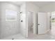 Tiled walk-in shower with a window in a spacious and bright bathroom at 14961 Sw 38Th Cir, Ocala, FL 34473
