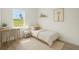 Well-lit bedroom with a serene ambiance, furnished with a twin bed and a small desk at 14961 Sw 38Th Cir, Ocala, FL 34473
