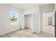 Bright bedroom with wood-look flooring, and a closet with bi-fold doors, and window with outside view at 14961 Sw 38Th Cir, Ocala, FL 34473